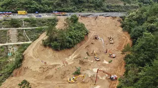 Rescuers and excavators working at the site of the incident
