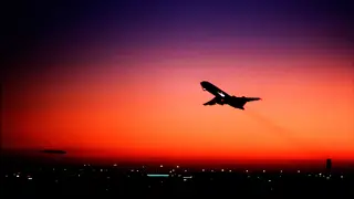 Plane takes off at dusk