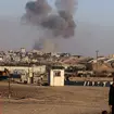 Smoke rises following an Israeli airstrike on buildings near the separating wall between Egypt and Rafah, southern Gaza Strip