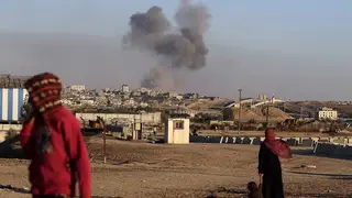 Smoke rises following an Israeli airstrike on buildings near the separating wall between Egypt and Rafah, southern Gaza Strip