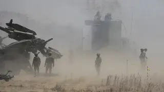 Dust billows as Philippine Army fires Atmos 155mm howitzers during a joint military exercise in Laoag, Ilocos Norte