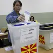 A woman casts her ballots for the parliamentary election and the presidential runoff, at a polling station in Skopje, North Macedonia