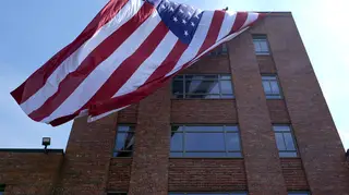 A giant American flag is unfurled on Lisner Hall on the campus of George Washington University in Washington