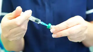 Nurse prepares MMR vaccine at GP health centre