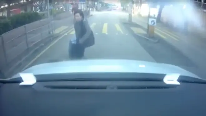 Woman throws herself at car bonnet