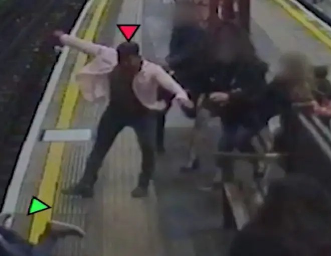 The shocking moment the passenger is shoved on to the tracks