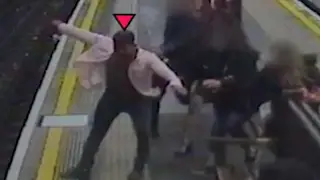 The shocking moment the passenger is shoved on to the tracks