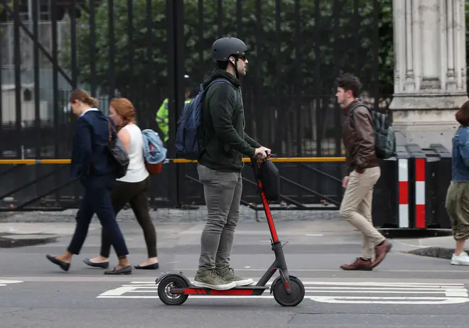 A person rides an electric scooter in Westminster