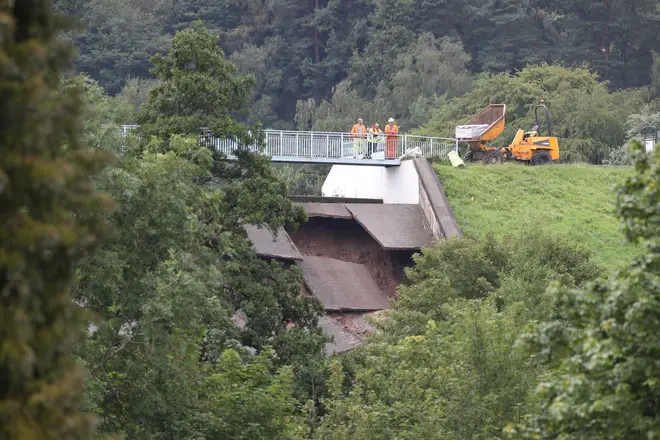 Engineers investigate damage to the wall of Toddbrook Reservoir near the village of Whaley Bridge, Cheshire, after it was damaged in heavy rainfall