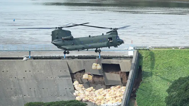 AN RAF Chinook drops stones in an attempt to save the town.