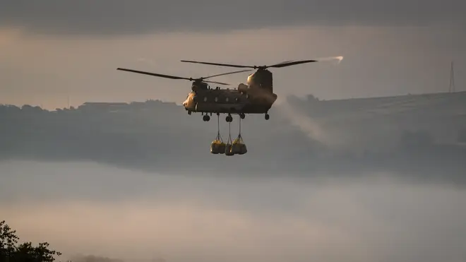 An RAF Chinook assists in the repair operation at Whaley Bridge after the dam began to collapse