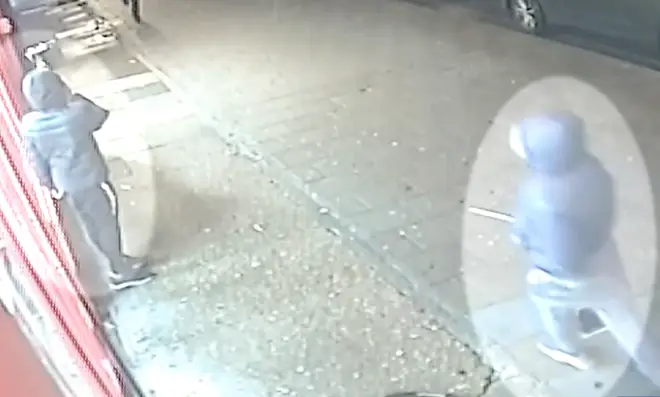 Baptiste is pictured on CCTV holding a large knife in the moments before the attack