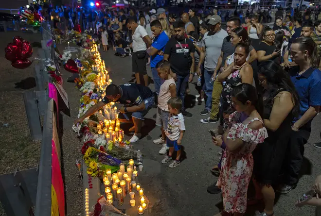 People gather at makeshift memorial for the victims of Saturday's mass shooting at a shopping complex in El Paso, Texas, Sunday, Aug. 4. Picture: PA
