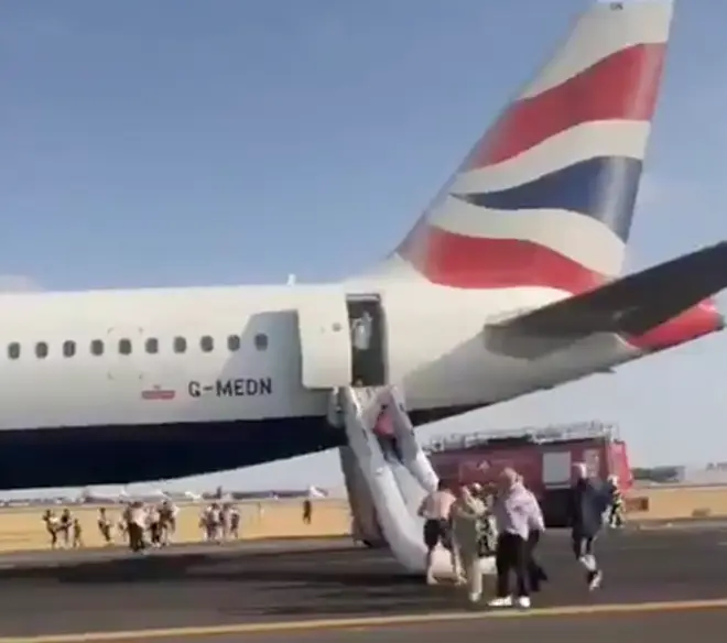 The BA flight as passengers are evacuated