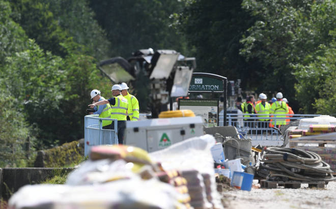 Work continues to shore up the dam at Toddbrook Reservoir near the village of Whaley Bridge, Derbyshire, after it was damaged in heavy rainfall