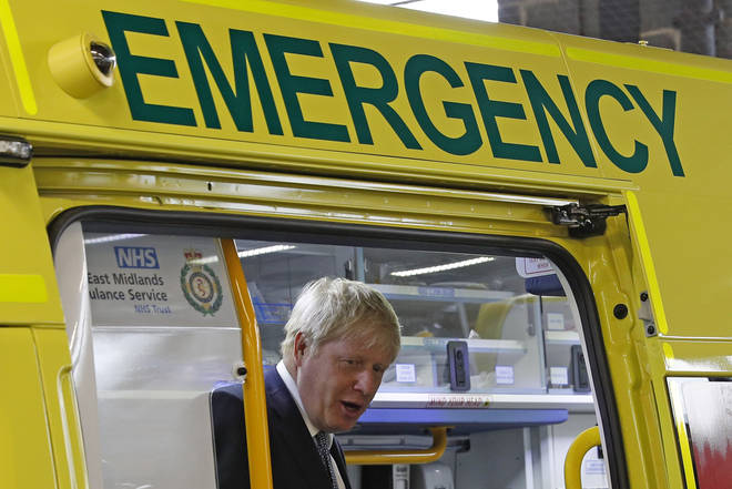 Prime Minister Boris Johnson inspects an ambulance during a visit to Pilgrim Hospital in Boston, Lincolnshire, to announce the government's NHS spending pledge of 1.8 billion