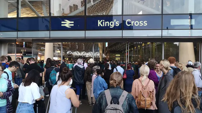 Passengers queueing outside Kings Cross station in London after power cut left services suspended for several hours
