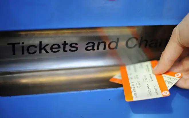 A passenger buying train ticket at Finsbury Park station, London.