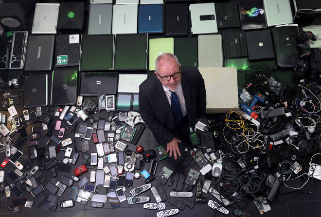 Robert Parker, the CEO of the Royal Society of Chemistry, with some of the redundant tech gathered by staff.