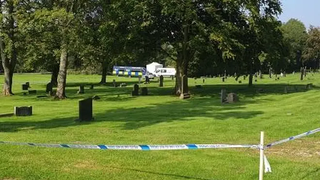 A teenage boy has been arrested on suspicion of murder after a teaching assistant was found dead in a cemetery