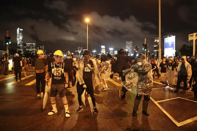Protesters taunt police near the Chinese People's Liberation Army Forces Building in Hong Kong