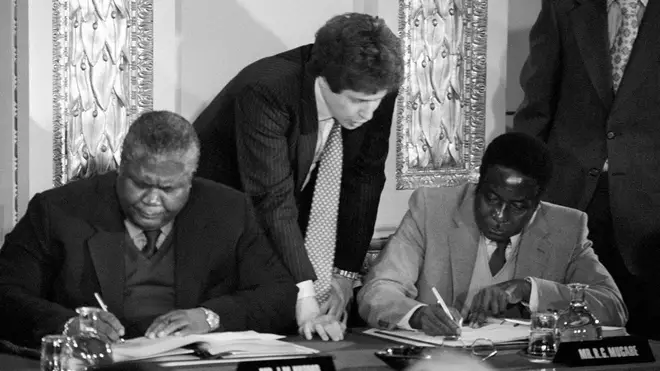 Guerrilla leaders Joshua Nkomo (L) and Robert Mugabe (R) signing the Rhodesia ceasefire agreement