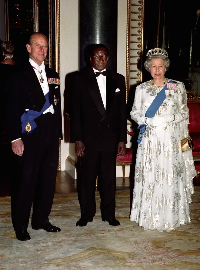 He was an outspoken critic of the UK, calling it an "enemy country". He is pictured here with Queen Elizabeth and Prince Philip