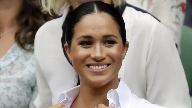Meghan Markle, pictured here at Wimbledon, has flown out on a commercial plane to watch the US Open