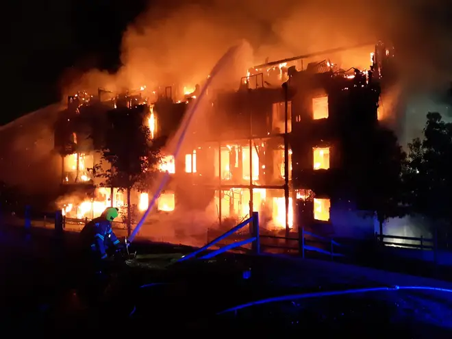 Firefighters tackle the blaze at the block of flats