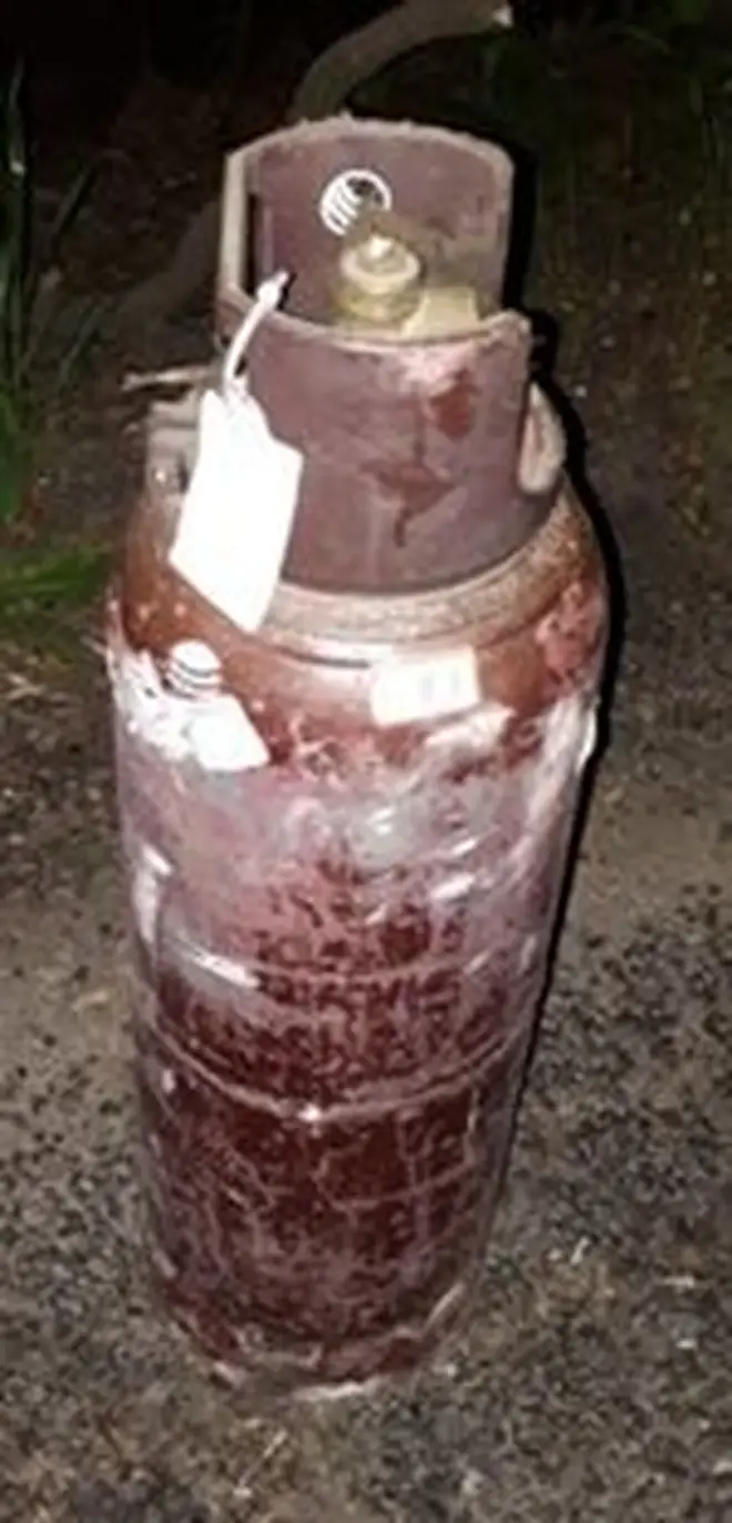 A maroon gas canister was recovered by police during their pursuit of the would-be robbers