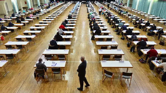 A report has suggested all watches should be banned from exam halls in order to battle cheating