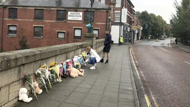 Tributes being laid at the scene where Zakari was reportedly thrown from a bridge