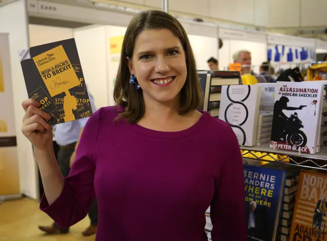 Jo Swinson holds a signed copy of her party's special edition manifesto during a tour of exhibition stands at the Liberal Democrats autumn conference at the Bournemouth International Centre in Bournemouth.