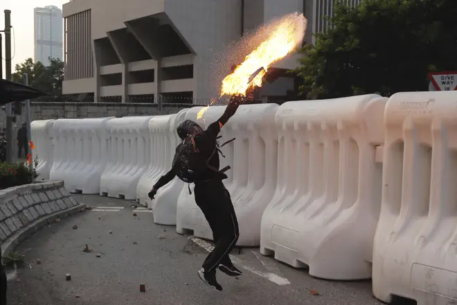 An anti-government protester throws a Molotov cocktail during a demonstration near Central Government Complex in Hong Kong.