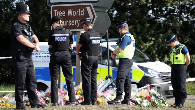 Officers pay their respect to their colleague at the scene of the crime in Berkshire