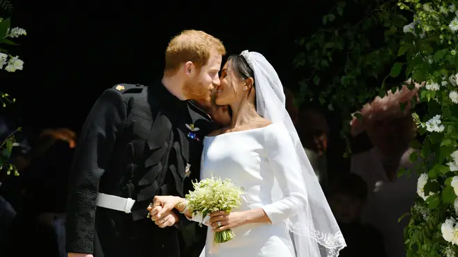 The Duke and Duchess of Sussex share a kiss as they leave the chapel.