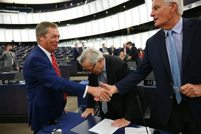 Brexit Party leader Nigel Farage shakes Michel Barnier's hand at the start of the debate in Strasbourg