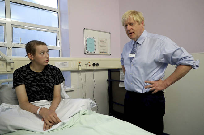 Prime Minister Boris Johnson meets a young patient during a visit to Whipps Cross University Hospital in Leytonstone, east London.