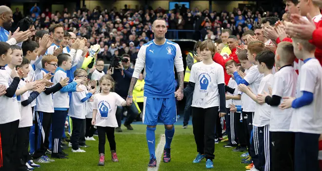 Fernando Ricksen walks out to greet the crowd before his tribute match at the Ibrox Stadium.