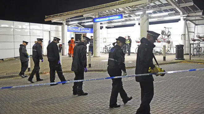 Officers scour the area at Hillingdon Police station following a fatal stabbing