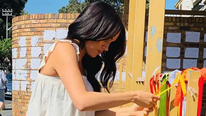 Meghan Markle ties a ribbon in memory of the murdered student whose death rocked South Africa