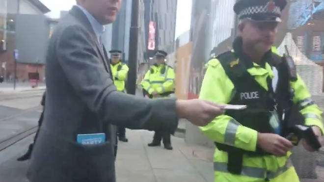 Mr Godwin was pictured handing money over to the protestors