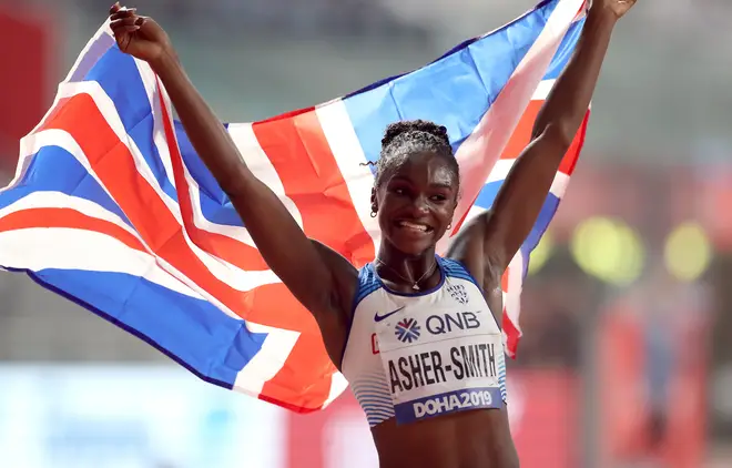 Dina Asher-Smith celebrates as she wins gold in the women's 200m final at Doha