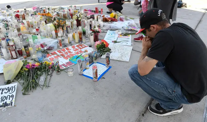 A man prays by a makeshift memorial along Las Vegas Blvd in October 2017
