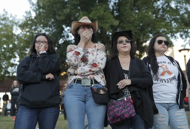 Mourners attend a ceremony on Tuesday, Oct. 1, 2019, on the anniversary of the mass shooting two years earlier