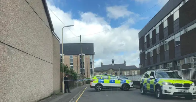 Police are outside the property in Pontypridd, South Wales