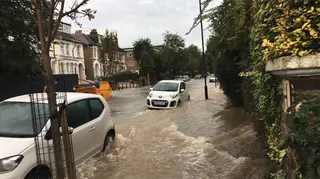 Major flood: a torrent of water flows through the street in north London