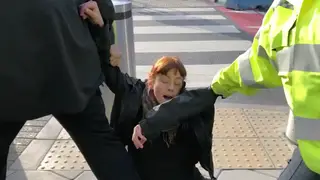 An Extinction Rebellion protester is being dragged away by police