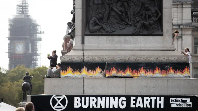 An Extinction Rebellion banner in London's Trafalgar Square warns about a "burning Earth"