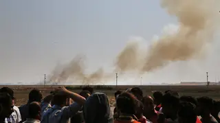 Smoke billows from fires on targets in Tel Abyad, Syria, caused by bombardment by Turkish forces